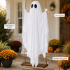 A white ghost decoration with a soft draped fabric hangs from a wooden swing seat for outdoor Halloween decor.