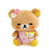 A cute brown bear plush toy with pink flowers on its head and a pink bag pendant.