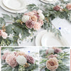 A lush floral garland featuring dusty rose, blush pink, and cream roses accented with green eucalyptus leaves for wedding dec