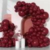 A large arrangement of deep burgundy latex balloons in various sizes and shapes.