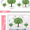 A set of three green tree wall stickers featuring pink blossoms and small birds, displayed in a bedroom setting.