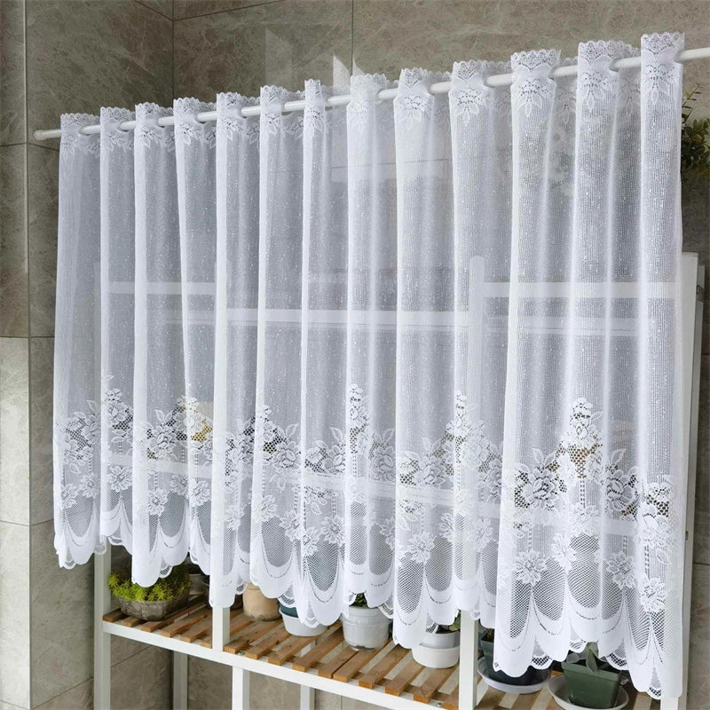 White lace mesh sheer curtains hanging on a rod, displayed with potted plants.