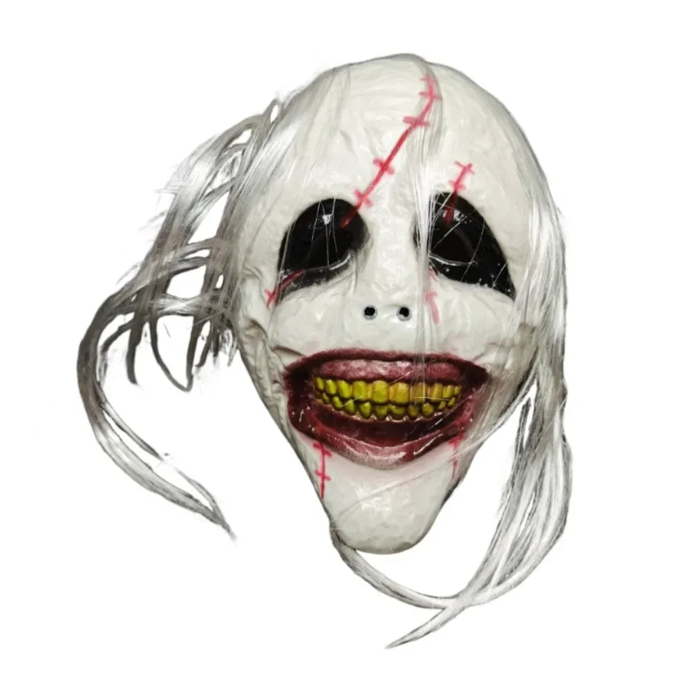 A realistic latex horror mask with pale skin, white hair, and a wide, bloody grin.