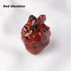 A reddish-brown obsidian heart carving decoration resting on a white background.
