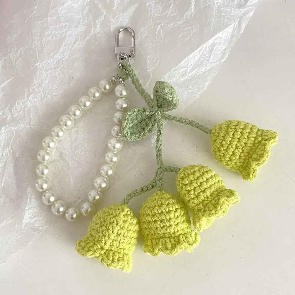 Handmade pearl chain orchid key ring featuring a green crocheted flower and yellow crocheted petals