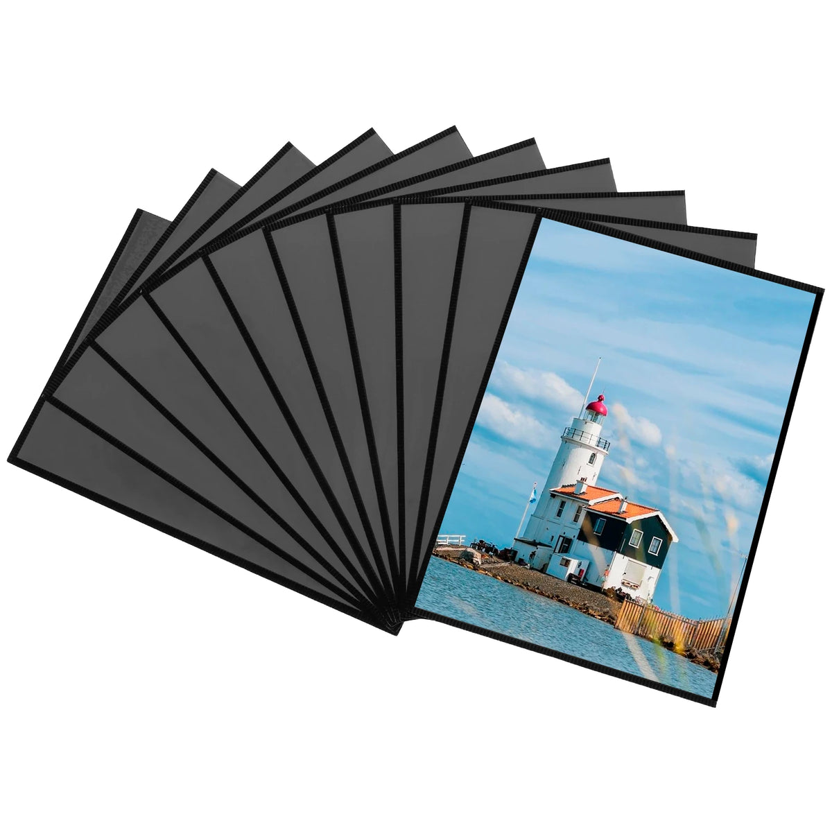 A set of black magnetic picture frames arranged in a fan shape, with one frame displaying a coastal lighthouse and building.