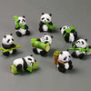 A set of mini resin panda bonsai figurines with green leaves and bamboo stalks.