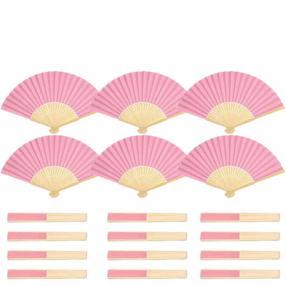 A set of pink paper hand fans with gift bags and thank you cards