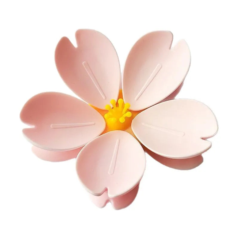 Pink magnetic cherry blossom sealing clips arranged around a yellow center.