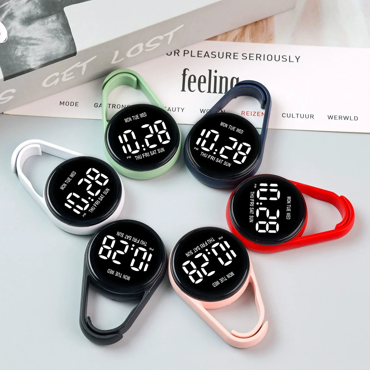 A collection of black LED pocket watches with various colored bands and touch controls displayed on a white background.