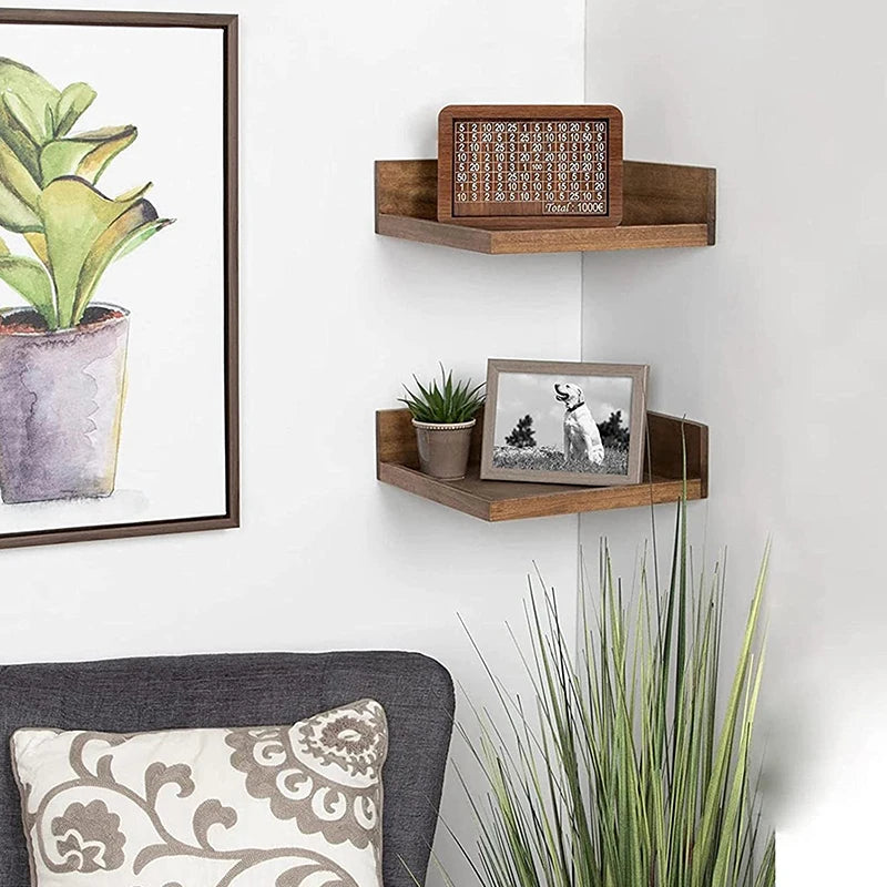A wooden piggy bank with a decorative grid pattern mounted on a floating shelf.