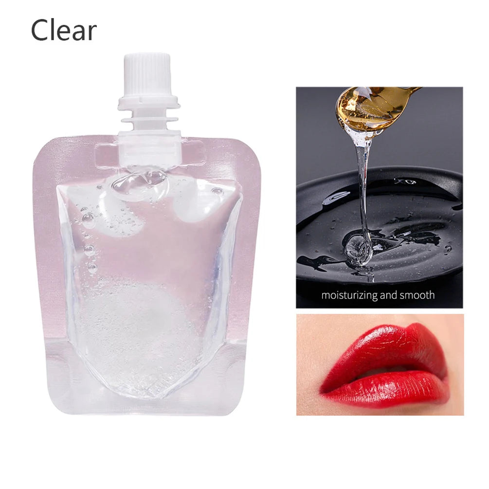Clear glass dropper bottle of nourishing fruit lip oil gloss with a drop of oil on the surface and a swatch of red lip oil.