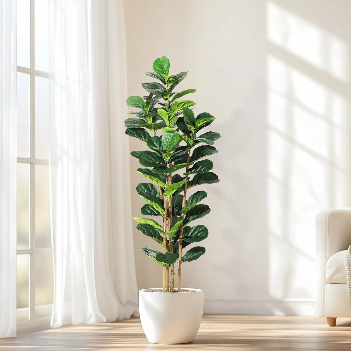 A realistic artificial fiddle leaf fig tree in a white pot standing next to a window.