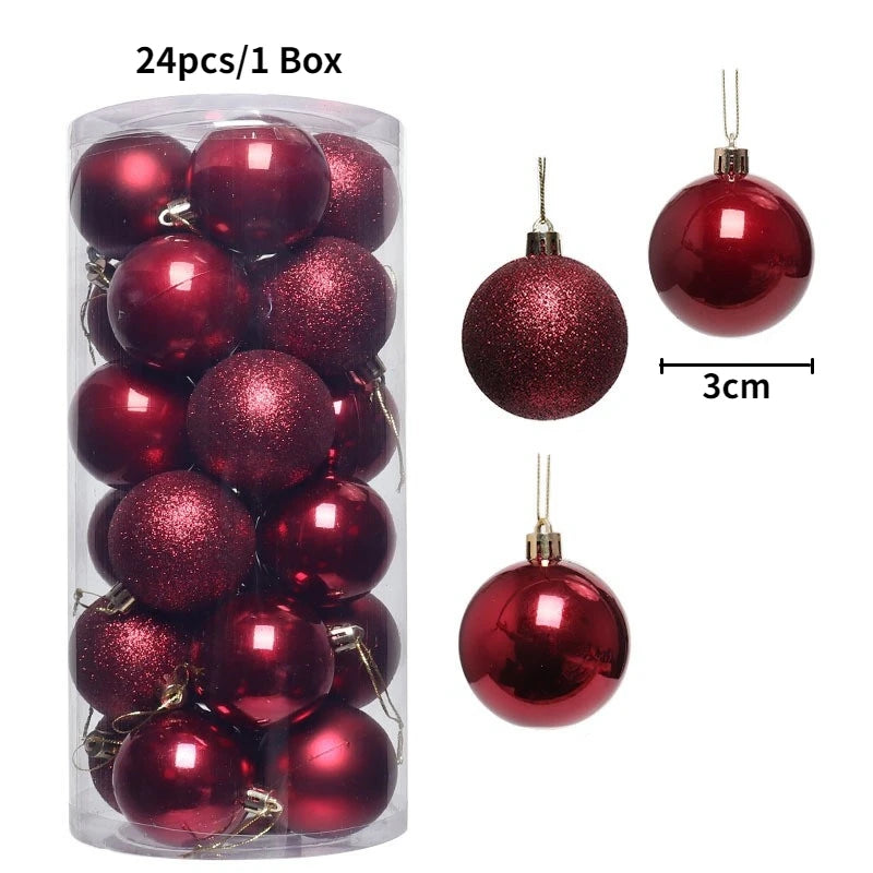 A box containing 24 festive red glitter Christmas tree ornament balls, with a scale showing the size of one ornament.