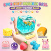 A hand holds an 8-piece set of soft, non-sticky squeeze balls including a large blue cube, a yellow cube, and various small t