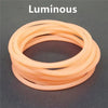 A set of ten luminous orange silicone bracelets arranged in a circle.