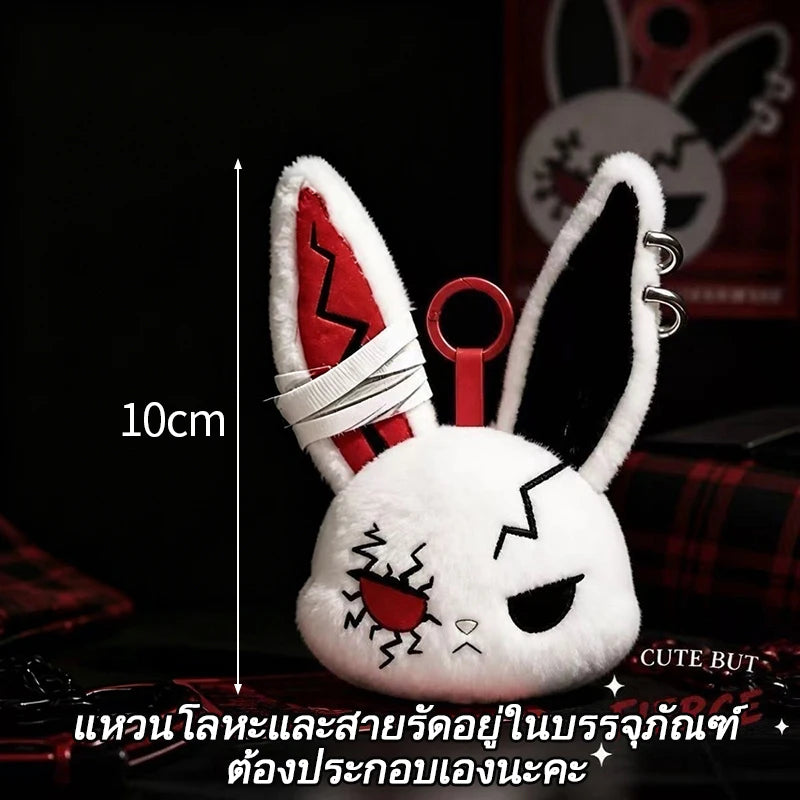 A white bunny plush keychain with red lightning bolt markings and black ears against a dark background.
