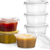 A stack of clear disposable plastic bowls with lids, including a jar of yellowish-green jam or preserve.