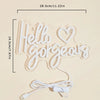 A white LED neon sign shaped like the words Hello Gorgeous with a USB power cord.