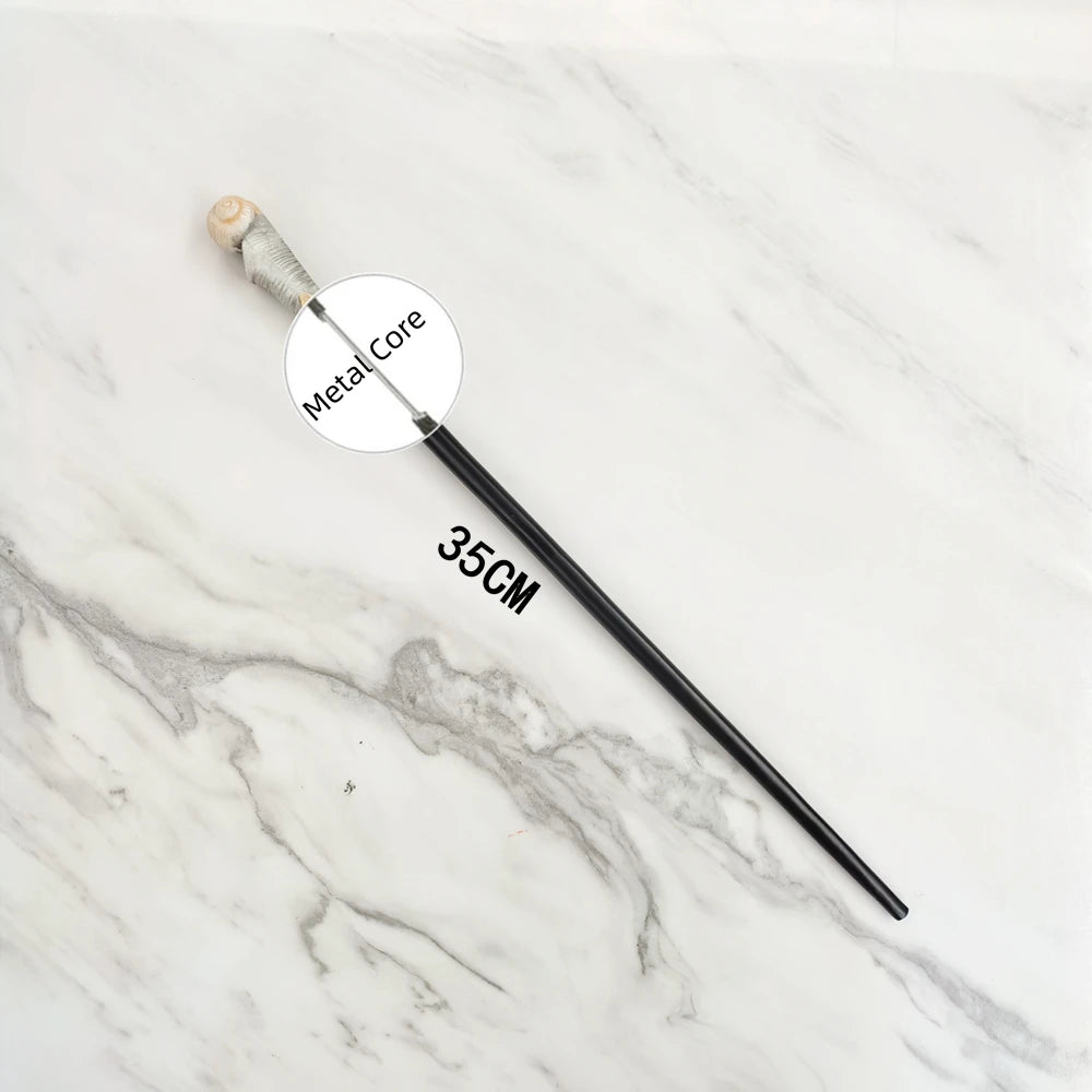 A black metal magic wand replica with a wooden handle is displayed on a white marble surface.