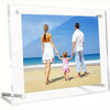 A clear acrylic photo frame displaying a family of three walking on a beach with blue water and sky.