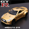 A gold 1:32 scale diecast GTR sports car model with racing decals shown in a studio setting.