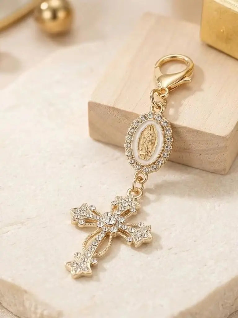 Gold pearl rhinestone cross keychain charm with a central oval and detailed design