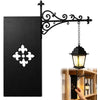 Black vintage gothic reading lamp with an ornate wrought iron bracket and warm amber glow