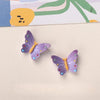 Purple resin butterfly and bee fridge magnets against a light background.