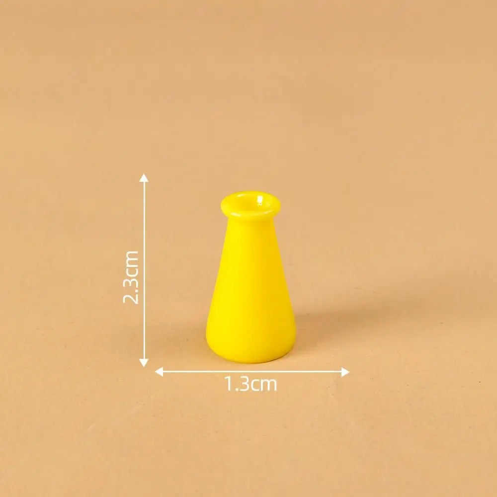 A bright yellow miniature resin vase with a flared opening, shown against a neutral background.