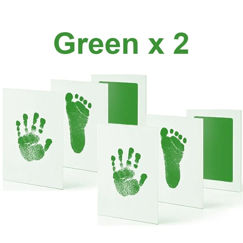 Green handprint and footprint ink pads kit showing green hand and foot prints on white paper.
