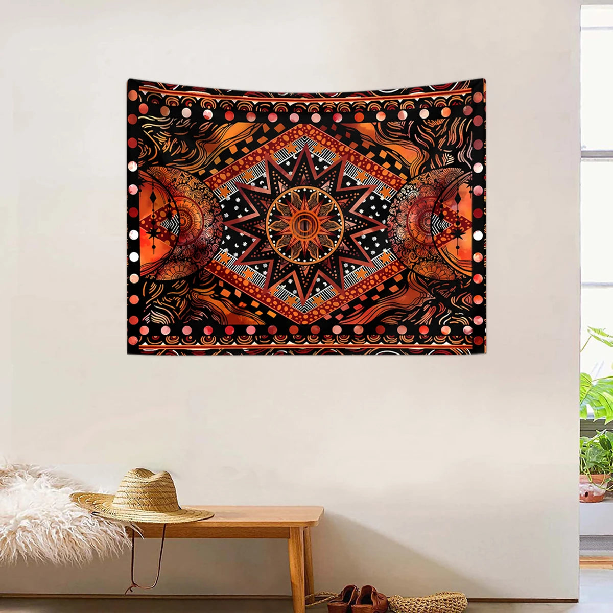 Bohemian sun and moon tapestry wall hanging featuring intricate geometric patterns in orange, black, and pink tones.