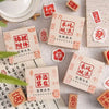 A collection of six square wooden Chinese character stamps featuring auspicious phrases like 招財 and 好运 for crafting.