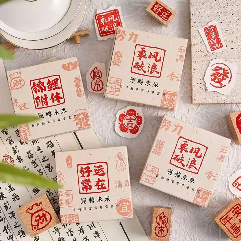 A collection of six square wooden Chinese character stamps featuring auspicious phrases like 招財 and 好运 for crafting.
