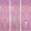 A vertical backdrop featuring shimmering pink and gold metallic foil tinsel fringe curtains.