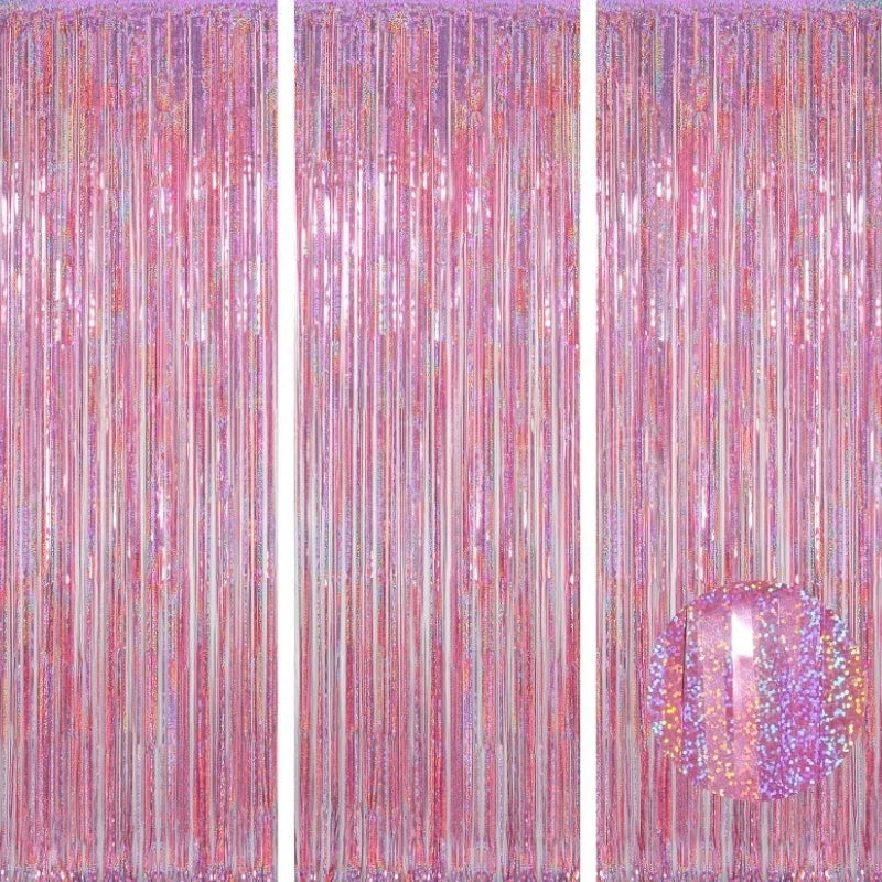A vertical backdrop featuring shimmering pink and gold metallic foil tinsel fringe curtains.