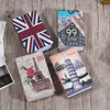 A collection of three books featuring British and Italian landmarks and a route map, displayed on a wooden surface.
