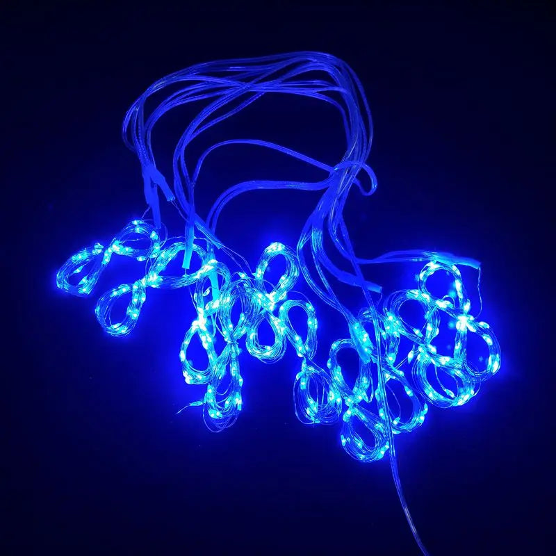 Blue LED curtain fairy lights with tangled strands glowing against a dark background