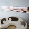 A set of four self-adhesive acrylic mirror wall stickers displayed horizontally on a white wall.