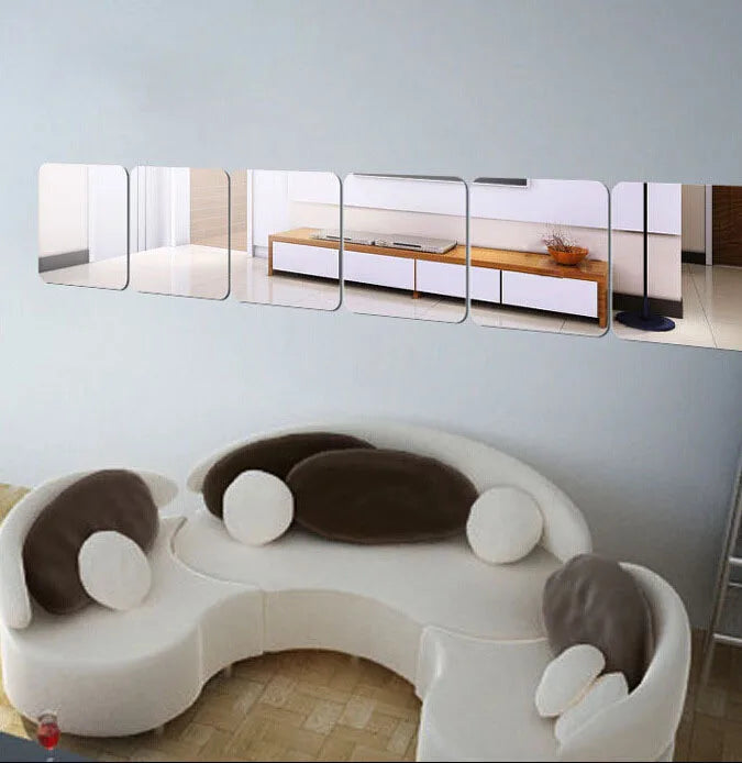 A set of four self-adhesive acrylic mirror wall stickers displayed horizontally on a white wall.