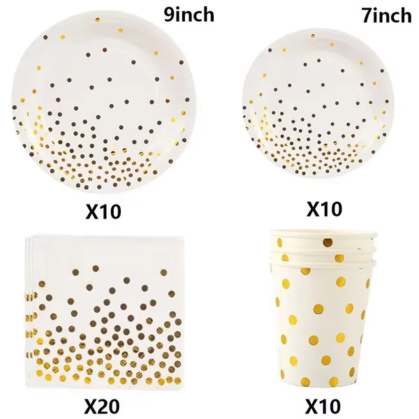 A set of white and gold disposable party tableware including plates, cups, and napkins with a dot pattern.