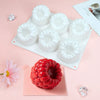 White silicone raspberry mousse molds arranged on a white tray with decorative sugar crystals nearby.