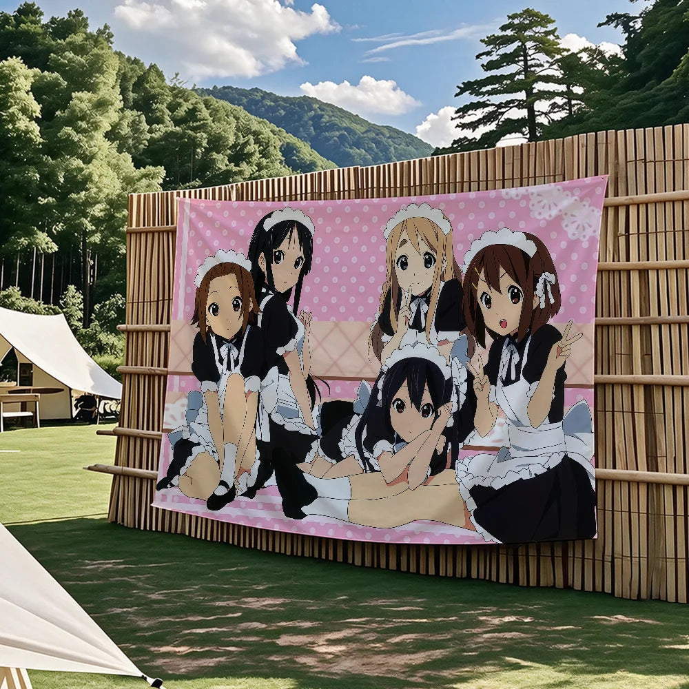 A large pink anime flag tapestry featuring characters from K-On! in a forest outdoor setting.
