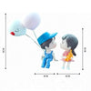 A set of two cute couple balloon car ornaments featuring a girl with blue overalls and a boy in a blue hat.