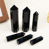 A collection of black obsidian crystal obelisks and rectangular points displayed on a white background.