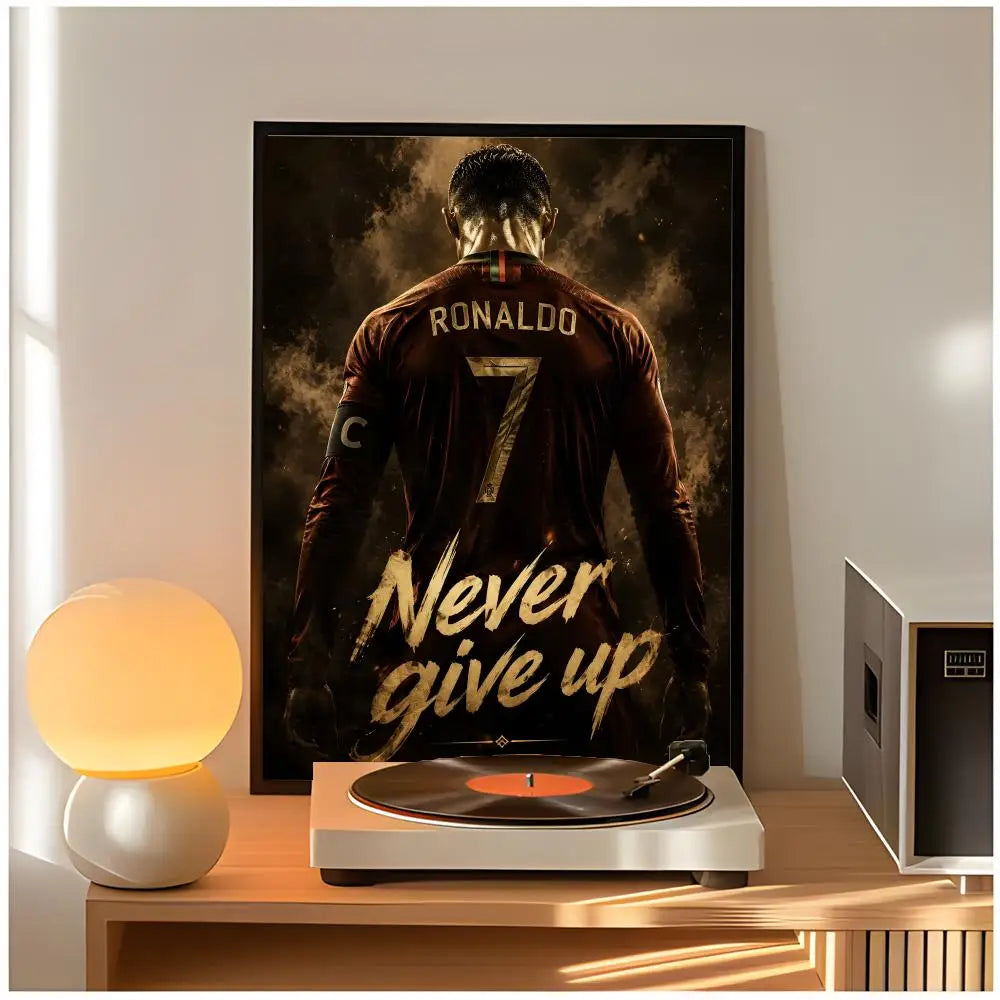 A poster of Cristiano Ronaldo in a dark jersey with the text Never give up displayed on a wooden shelf.