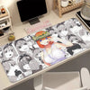 A desk mat featuring illustrations of the Quintessential Quintuplets anime characters with a non-slip rubber base.
