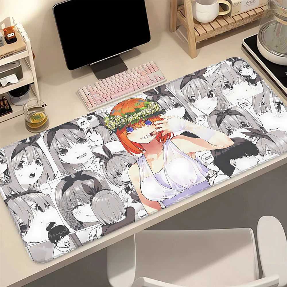 A desk mat featuring illustrations of the Quintessential Quintuplets anime characters with a non-slip rubber base.