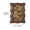 A vintage resin photo frame with a distressed brown border and an aged, dark botanical print.