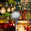 A collection of outdoor light string clips and decorative Christmas ornaments, including Edison bulbs and red glass balls.